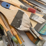Encaustic paint brushes with cooled wax in bristles