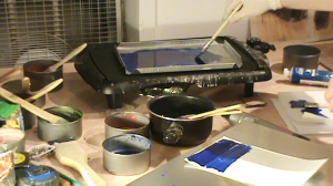 View of studio with hot skillet on table and pots of encaustic paint